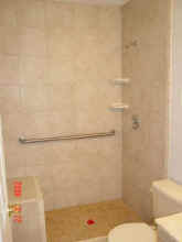 after- built a shower seat and mudded the shower pan for easy access. Installed grab bars.